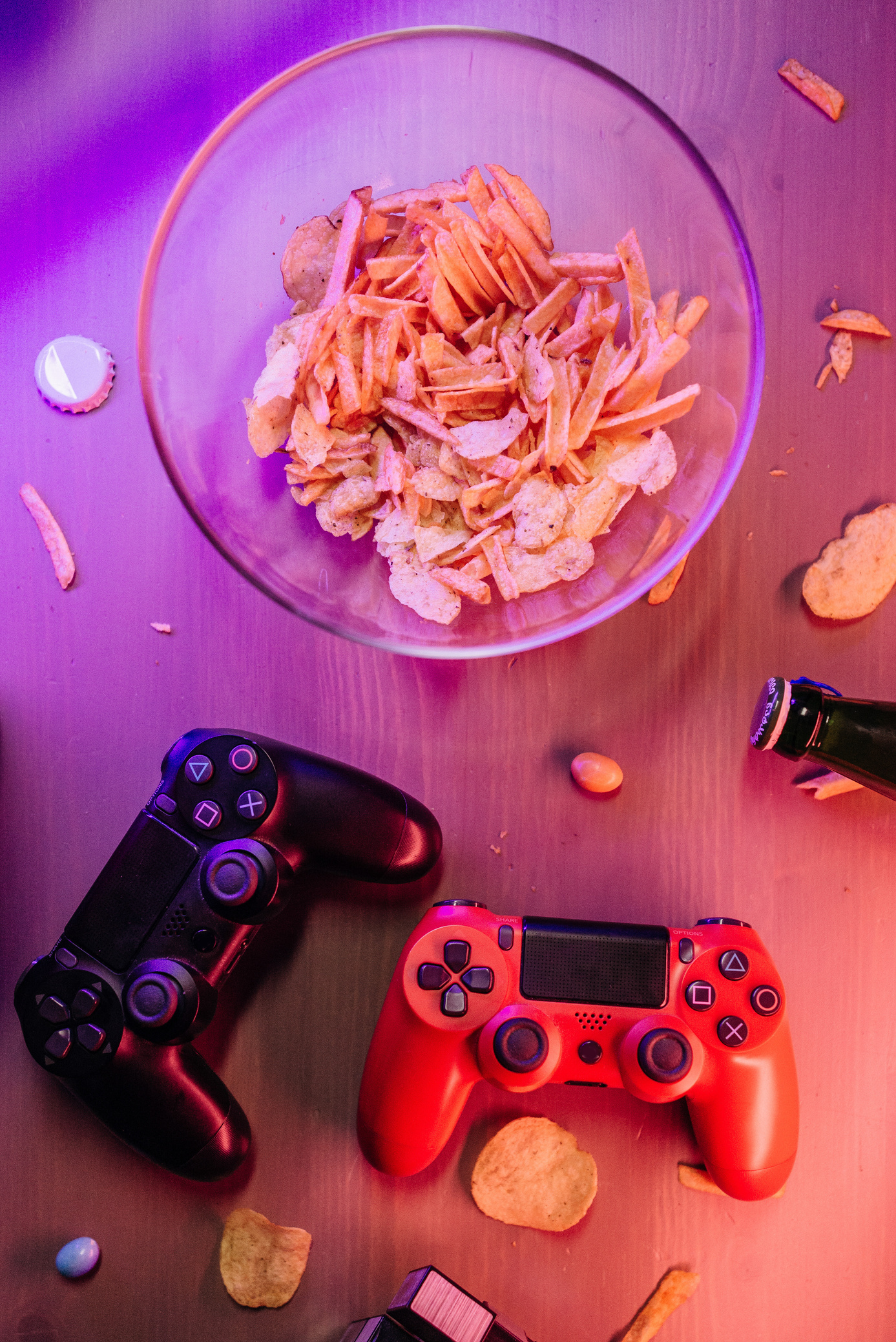 Game Controllers Beside a Bowl of Chips